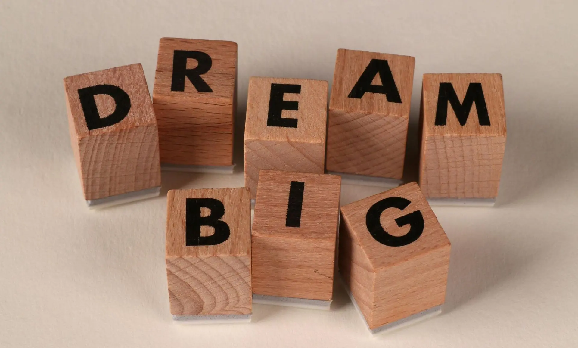 Wooden blocks spelling 'DREAM BIG'.